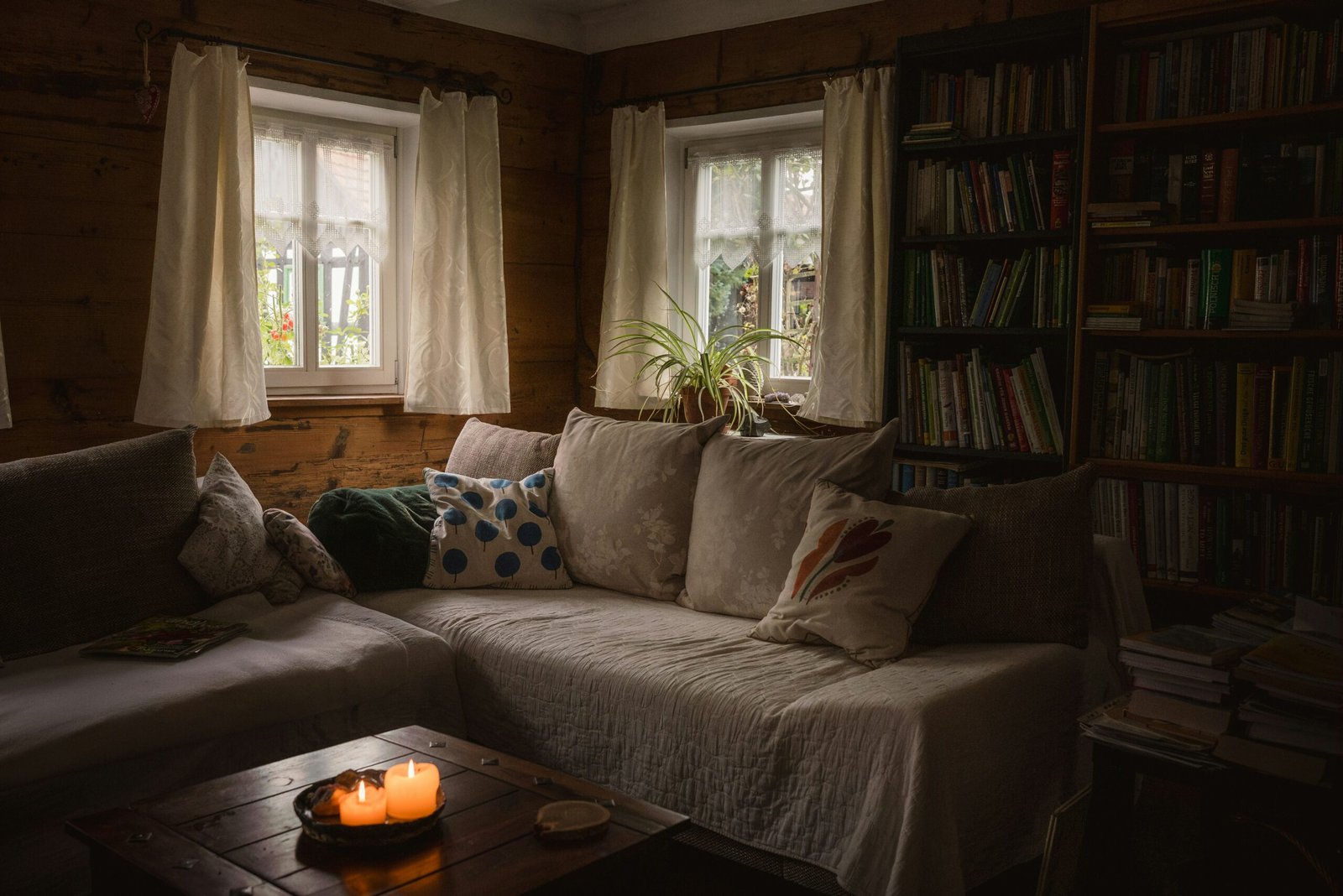 Cozy reading corner with books, warm mug and soft natural light